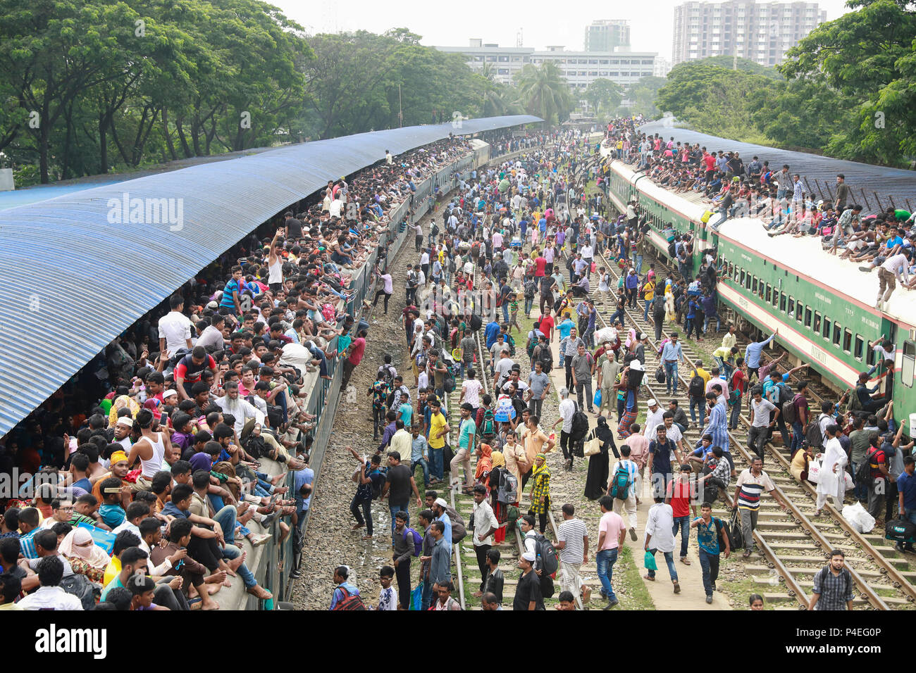 June 14, 2018- Dhaka, Bangladesh:  Muslims sit on top of trains as they travel to their hometowns ahead of the Muslim holiday of Eid al-Fitr. (Suvra K Stock Photo