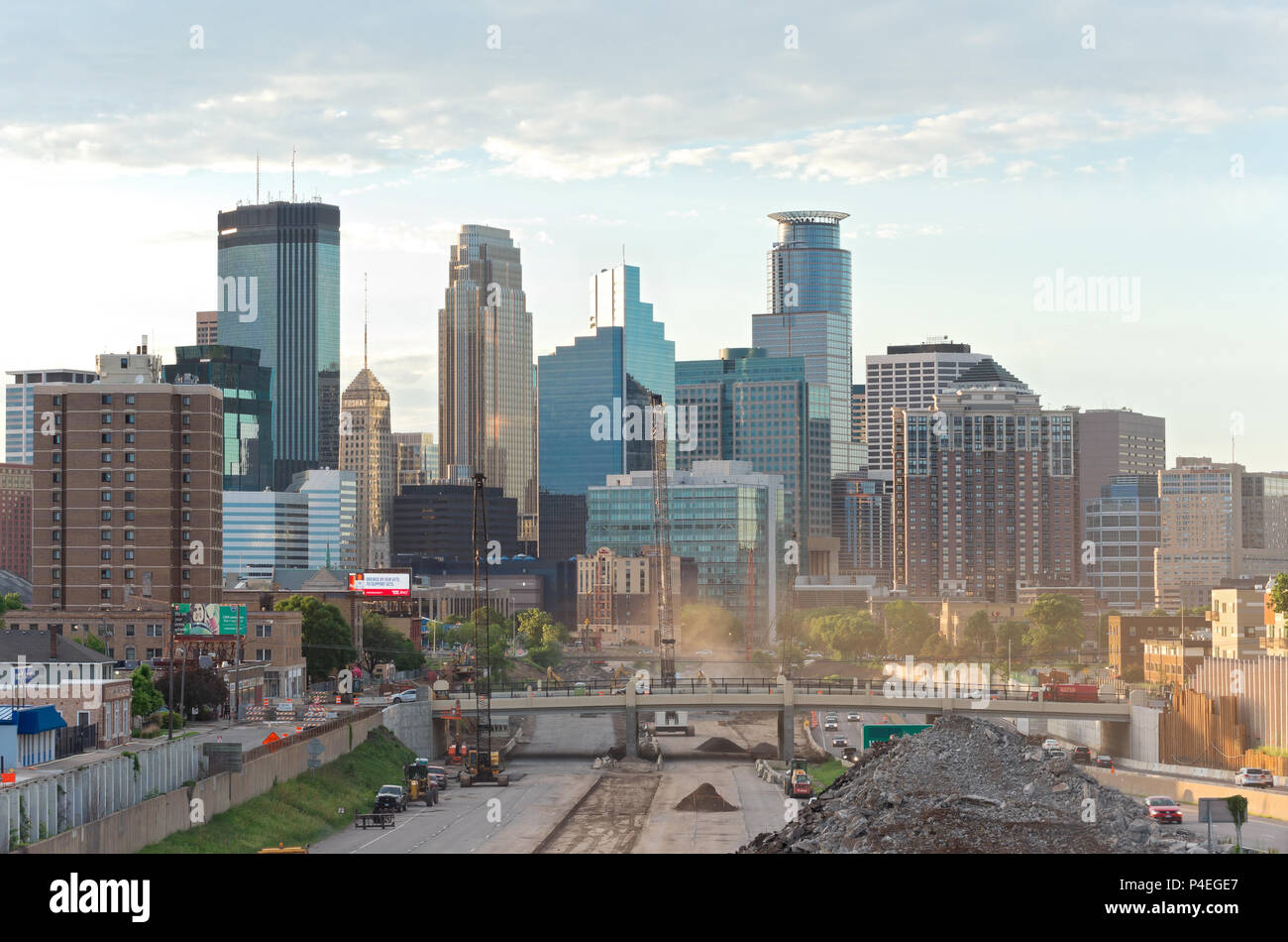 minneapolis skyline from 24th street pedestrian bridge overlooking 35w interstate into downtown showing reconstruction of interstate and office towers Stock Photo