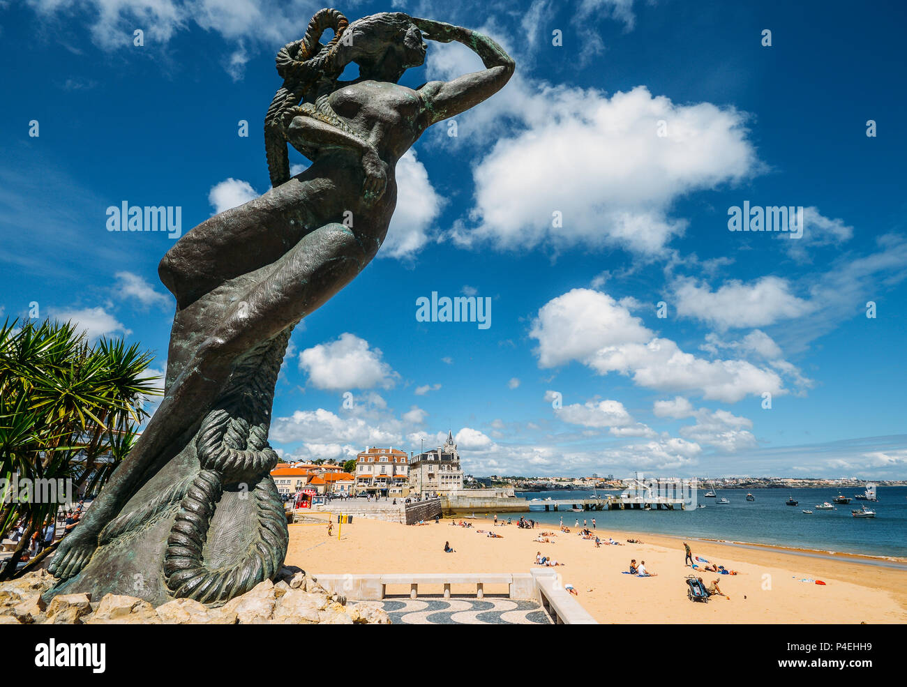 Close up of a mermaid statue looking out into the Atlantic sea at Praia da Ribeira, Cascais, Portugal Stock Photo