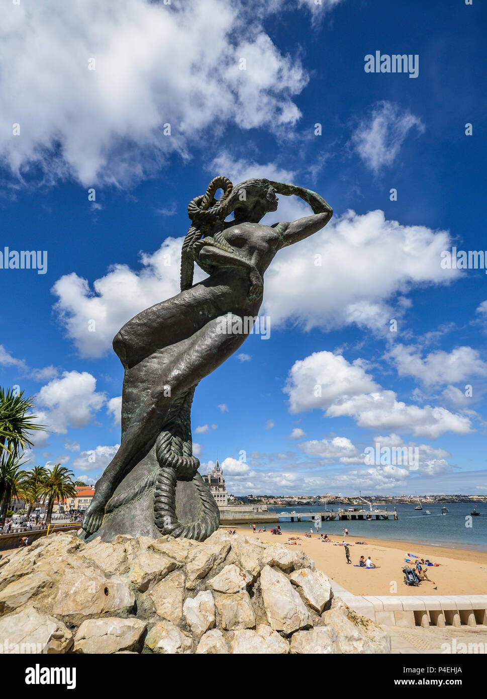 Close up of a mermaid statue looking out into the Atlantic sea at Praia da Ribeira, Cascais, Portugal Stock Photo