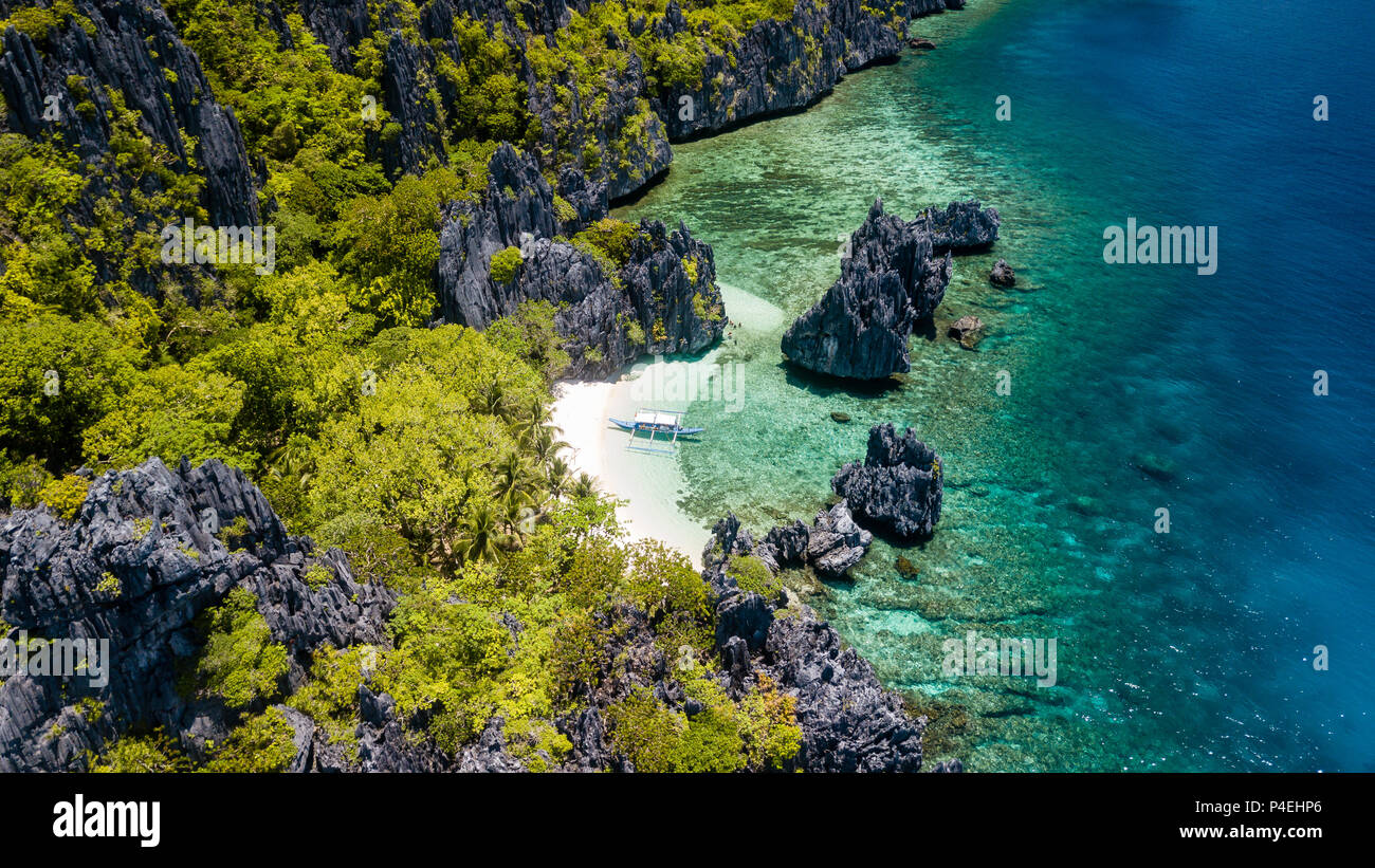 Aerial drone view of spectacular tropical scenery with towering cliffs, jungle and pristine sandy beaches Stock Photo