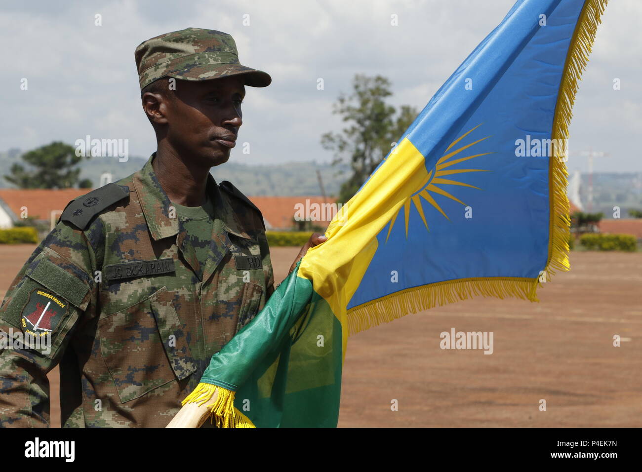 Rwanda Defence Force soldier, Justified Accord participant, holds the Rwanda flag in formation at the Justified Accord 2018 opening ceremony at the Ugandan Rapid Deployment Capability Center, Jinja, Uganda, June 18, 2018. JA18 brings together AMISOM troop contributing nations, partner nations from East Africa, and the U.S. to foster security cooperation while improving interoperability.(U.S. Army photo by Spc. Angelica Gardner) Stock Photo