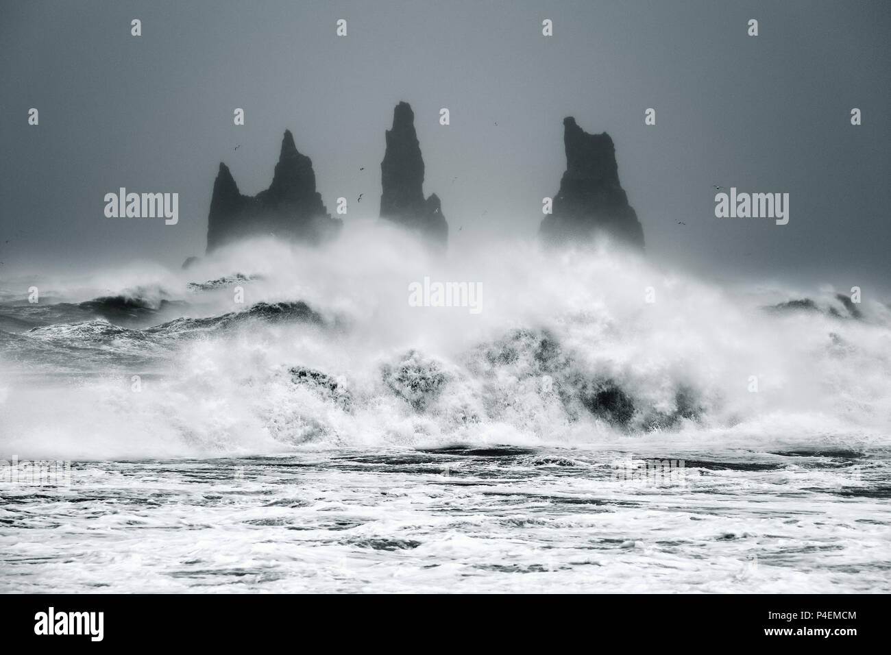 Waves crashing against sea stacks in ocean, Iceland Stock Photo