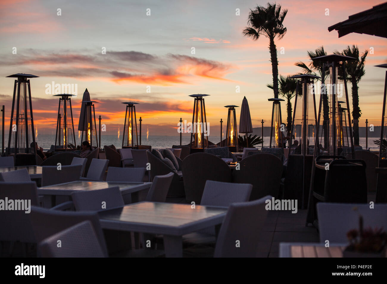Beautiful Romantic Sunset at the Beach Cafe with Outdoor Patio Heaters