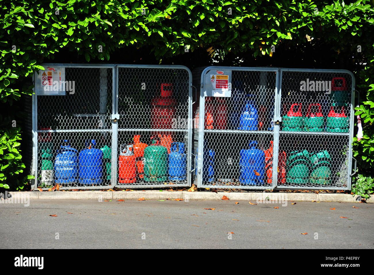 Bottled Gas Refills in safety locked cages at a fuel filling station Stock Photo