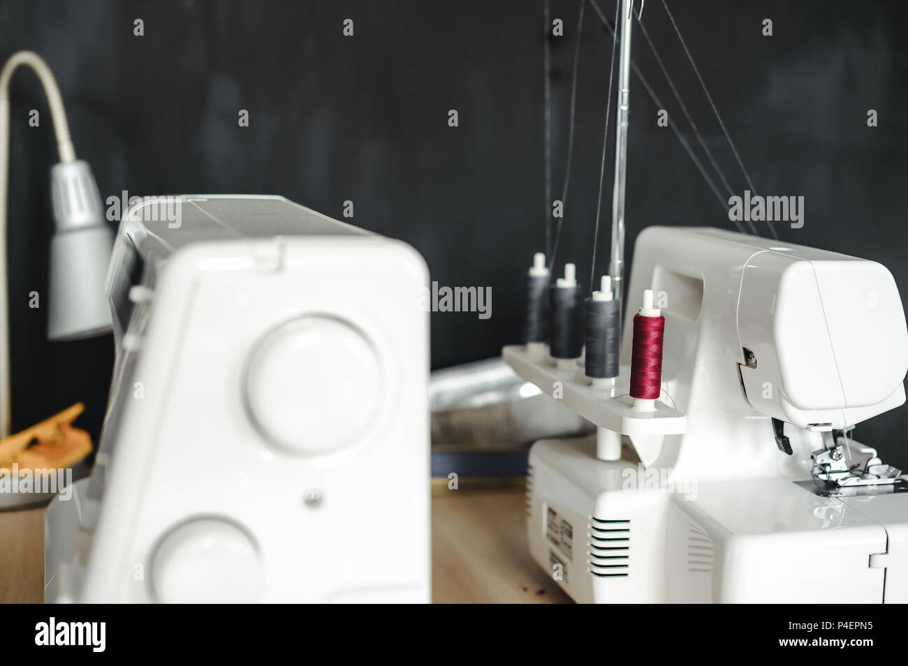 two white sewing machines on the seamstress's desk Stock Photo Alamy