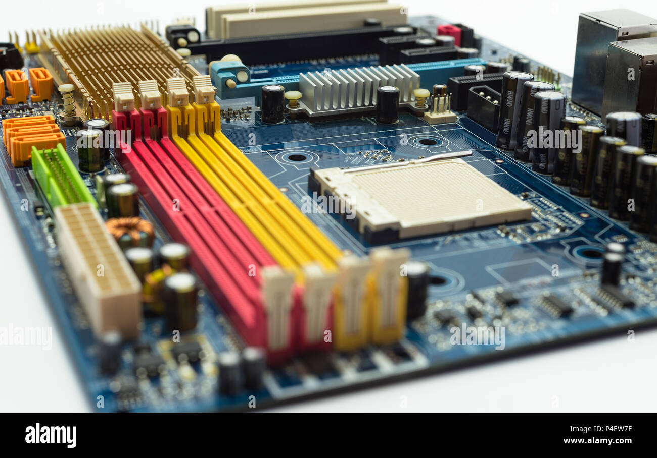 Motherboard with visible PCI express connector slot, heat sink, memory slot, cpu socket in blue. Stock Photo