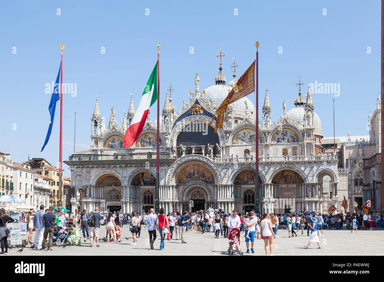 Flags flying in front of St Marks Cathedral on Liberation Day, Piazza San Marco, San Marco, Venice, Veneto, Italy Stock Photo