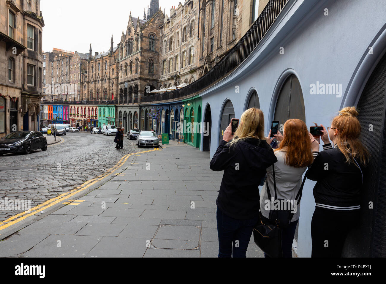 Edinburgh tourists - people taking a photo of West Bow, Edinburgh old town, Edinburgh, Scotland UK Stock Photo