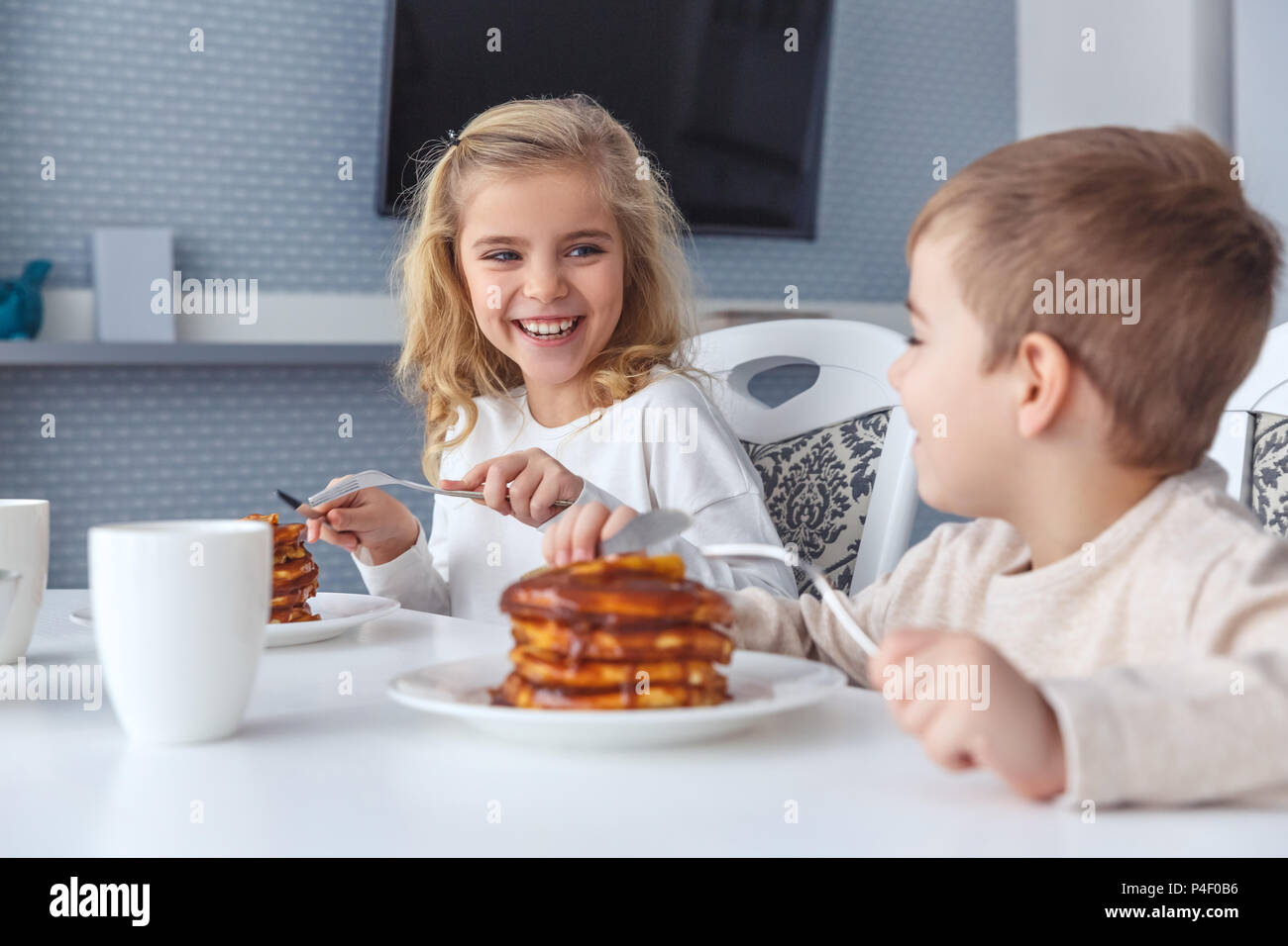 happy little kids having breakfast together Stock Photo