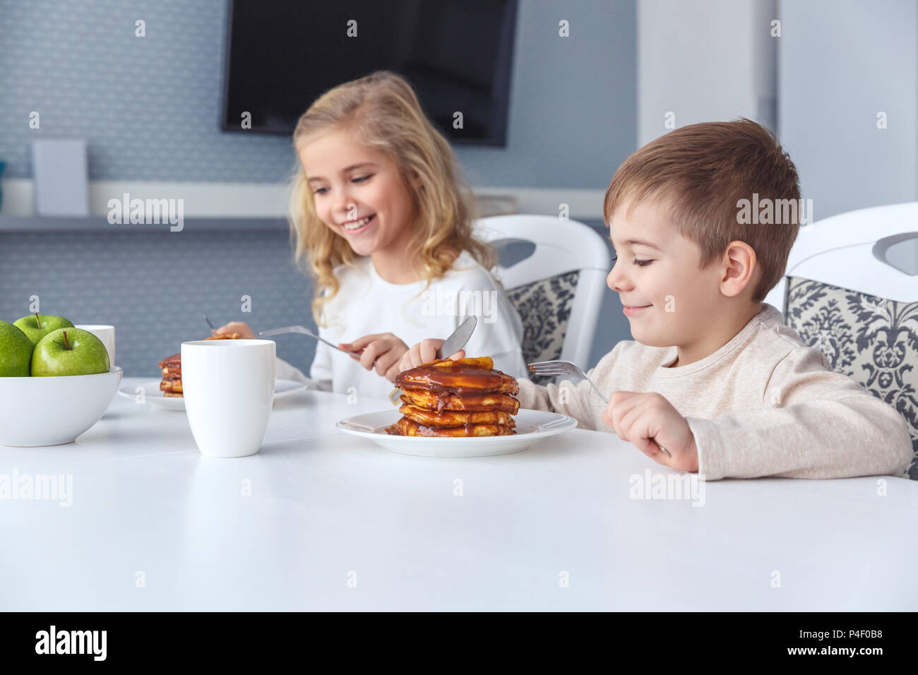 adorable little kids having breakfast together Stock Photo
