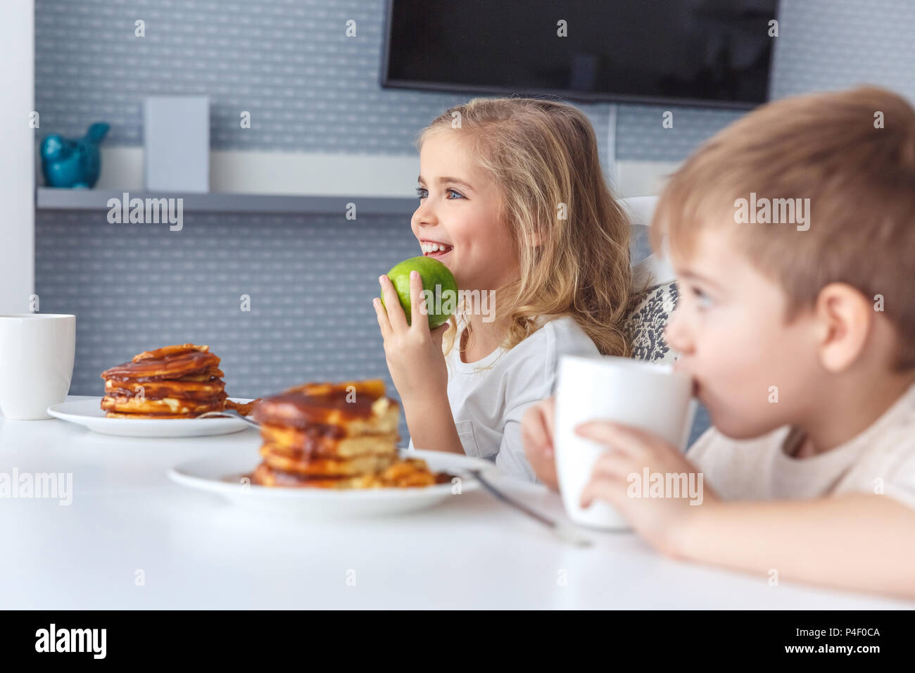 little kids having breakfast together Stock Photo