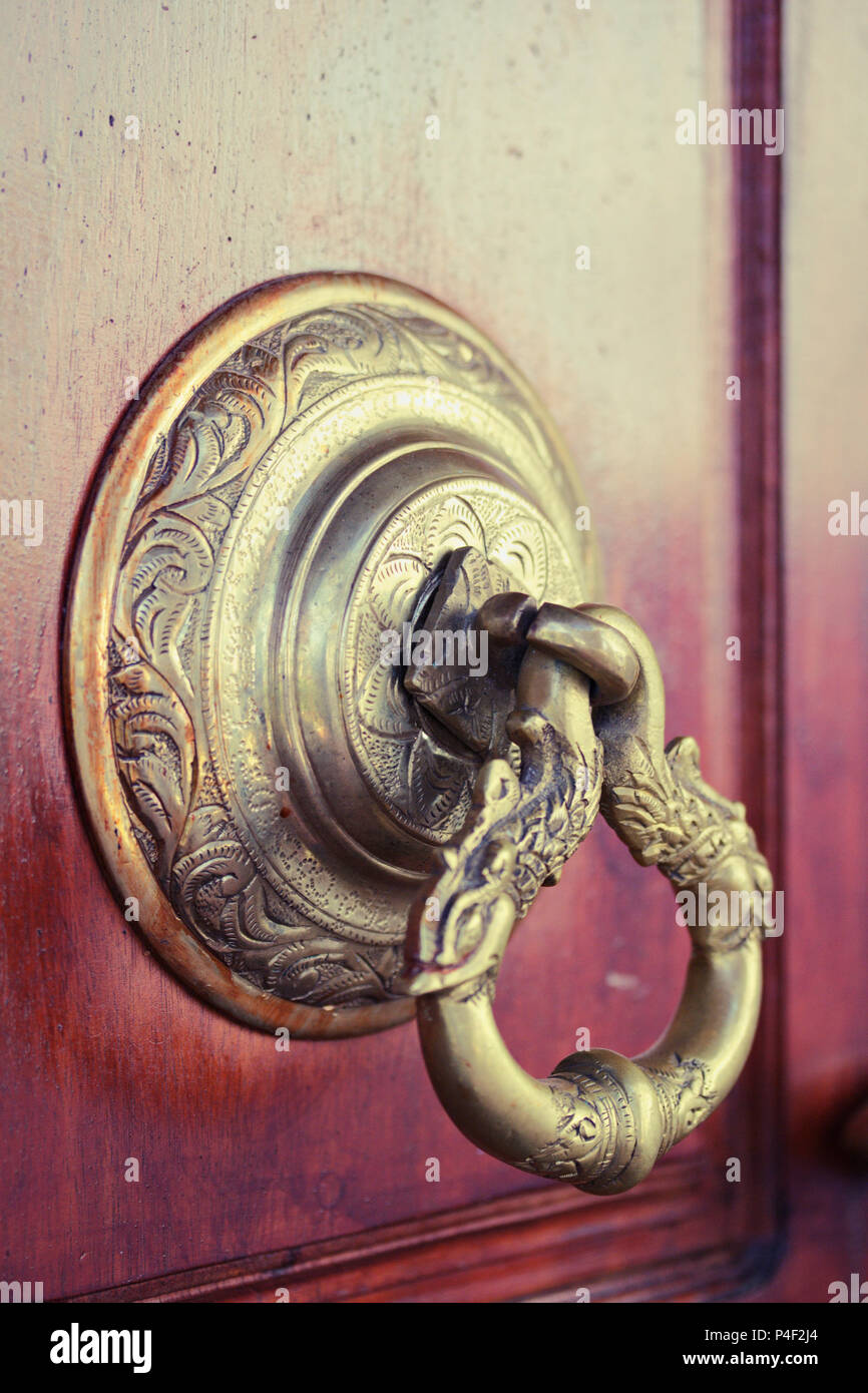 an antique indian doorknob at a temple door Stock Photo