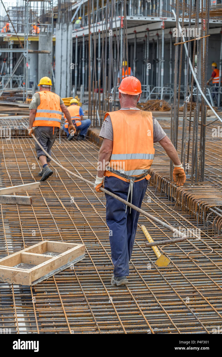 Worker carrying rebar hires stock photography and images Alamy