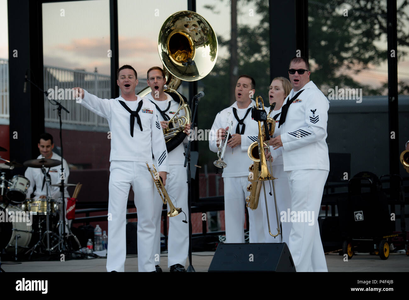 CARSON CITY, Nevada (June 19, 2018) Musician First Class Collin Reichow leads the crowd in song during a 32nd Street Brass Band #navyweek concert at McFadden Plaza. The Navy Office of Community Outreach uses the Navy Week program to bring Navy Sailors, equipment and displays to approximately 15 American cities each year for a week-long schedule of outreach engagements. (U.S. Navy Photo by Musician Second Class Nina Church/Released) Stock Photo