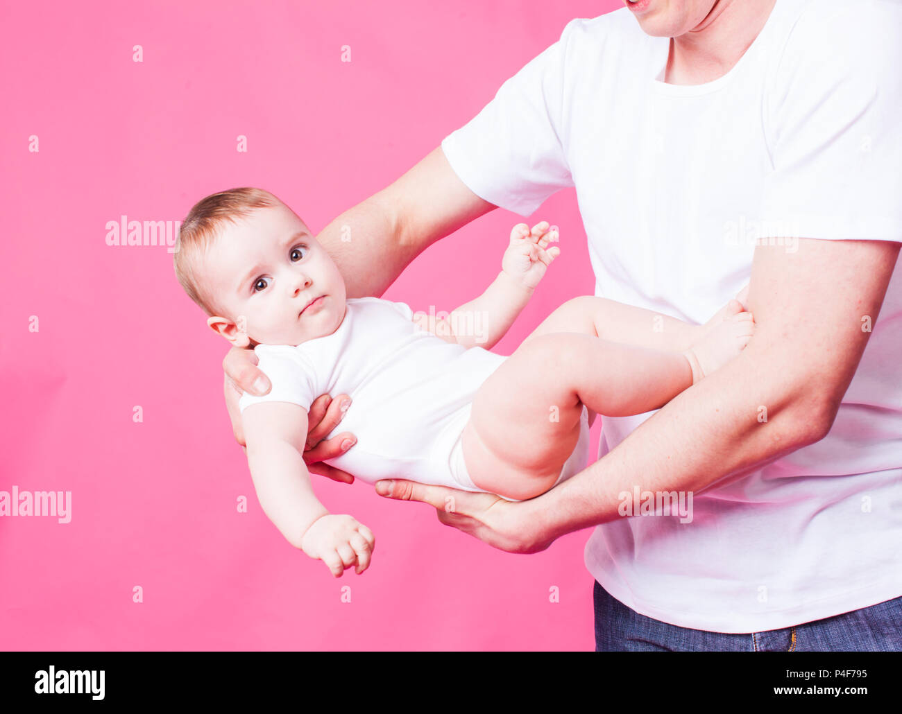 Father swings his baby in his arms Stock Photo Alamy