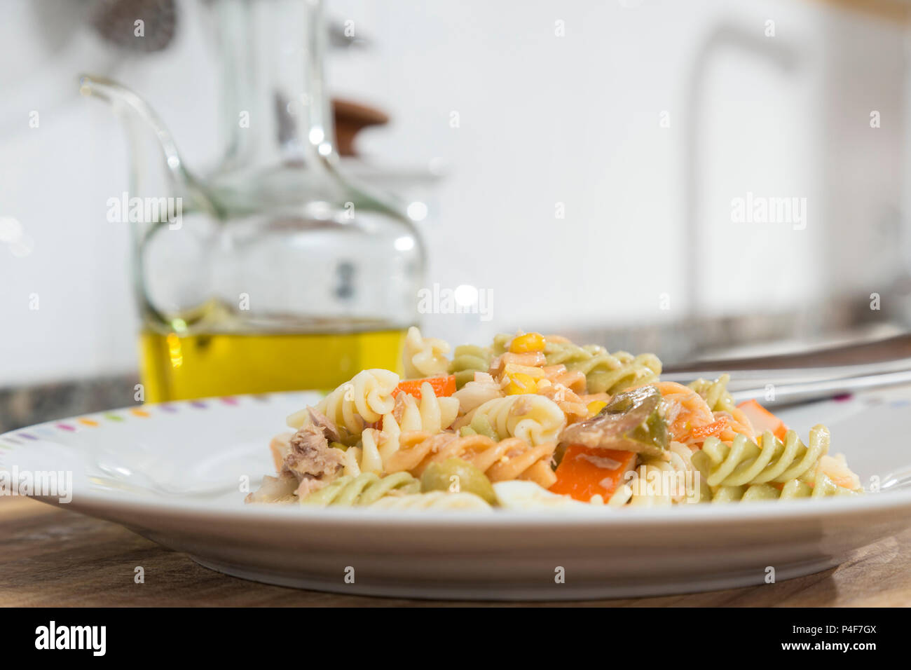 colorful curly macaroni salad with tomato, surimi, egg, corn and tuna