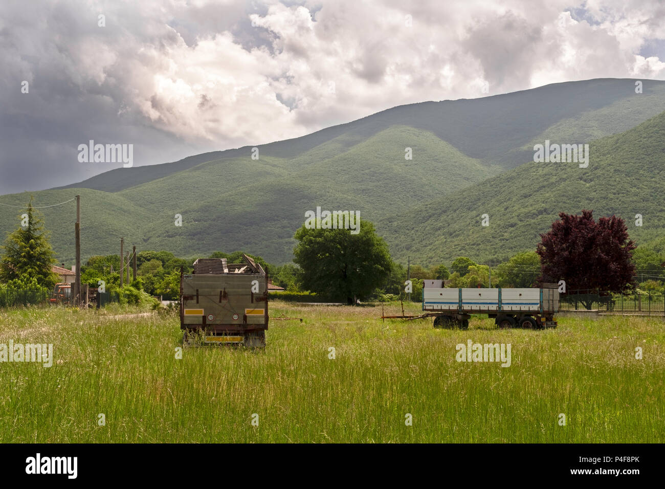 Farmers tractor trailers on a field in Italy Stock Photo
