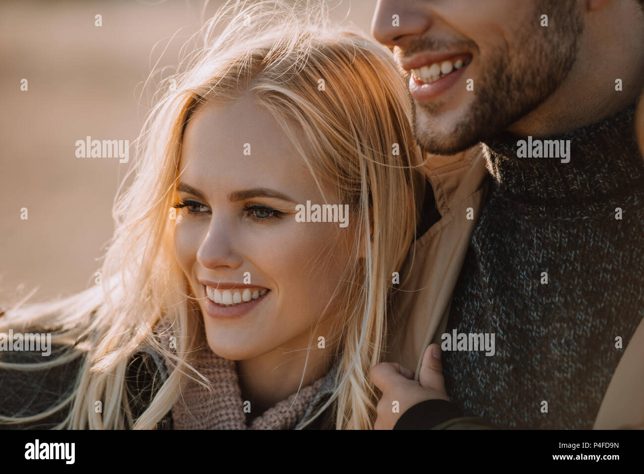 portrait of young smiling couple hugging together Stock Photo - Alamy