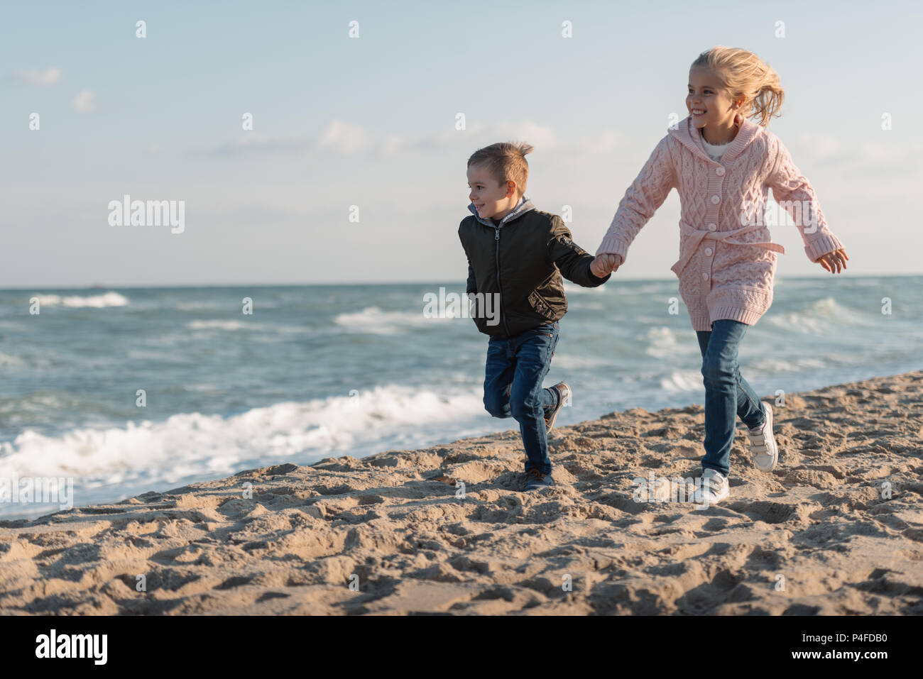 Brother sister running the beach hi-res stock photography and images ...