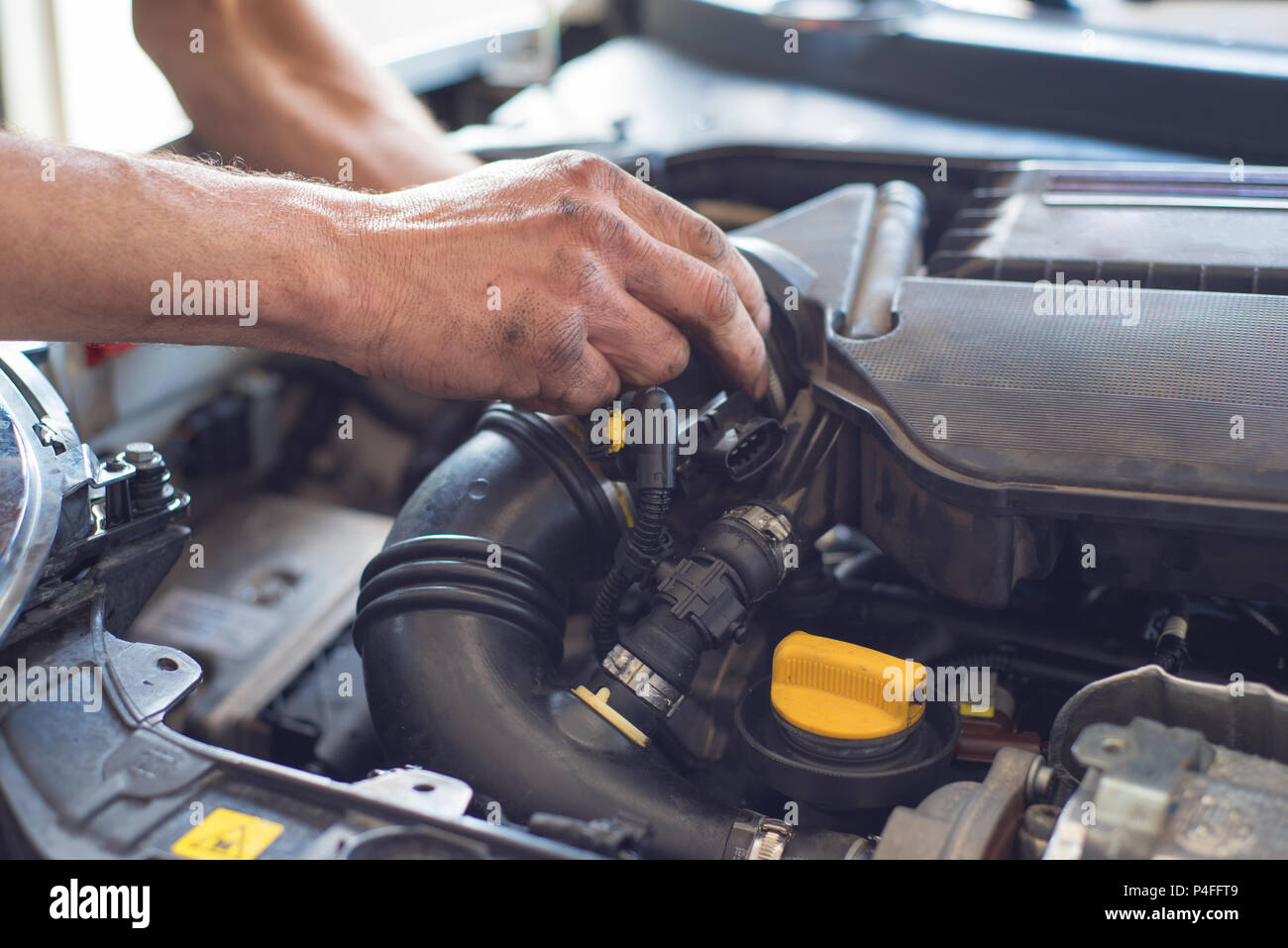 Auto mechanic repairing car. Selective focus. Stock Photo