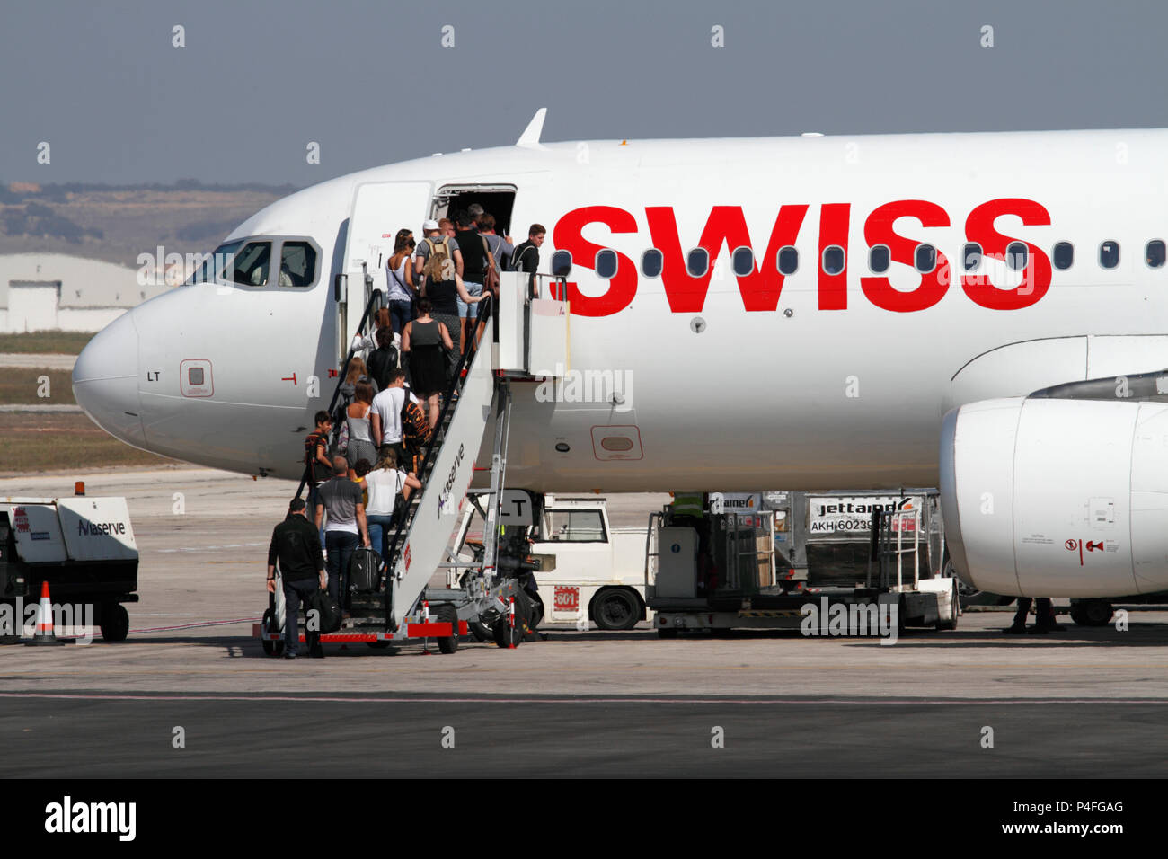 Passengers boarding a Swiss International Air Lines Airbus A320 jet plane before departure. Commercial air travel. Stock Photo