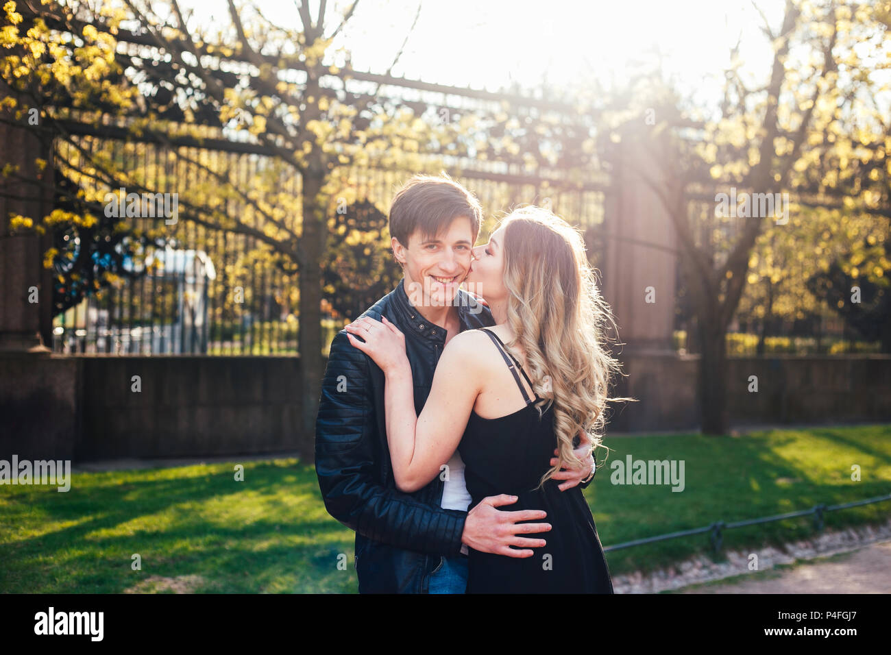 Young couple in love hugging and kissing on the street city Stock Photo ...