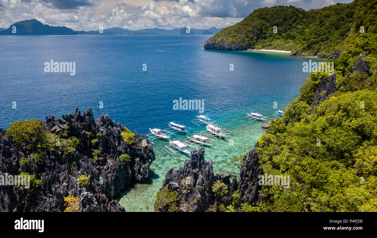 Aerial drone view of traditional boats next to a beautiful tropical lagoon Stock Photo