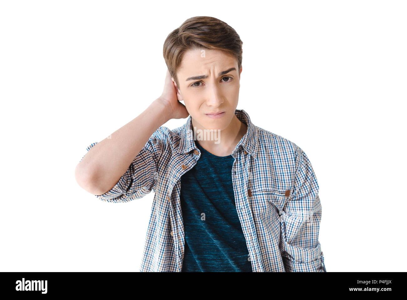 portrait of confused caucasian teenage boy looking at camera isolated