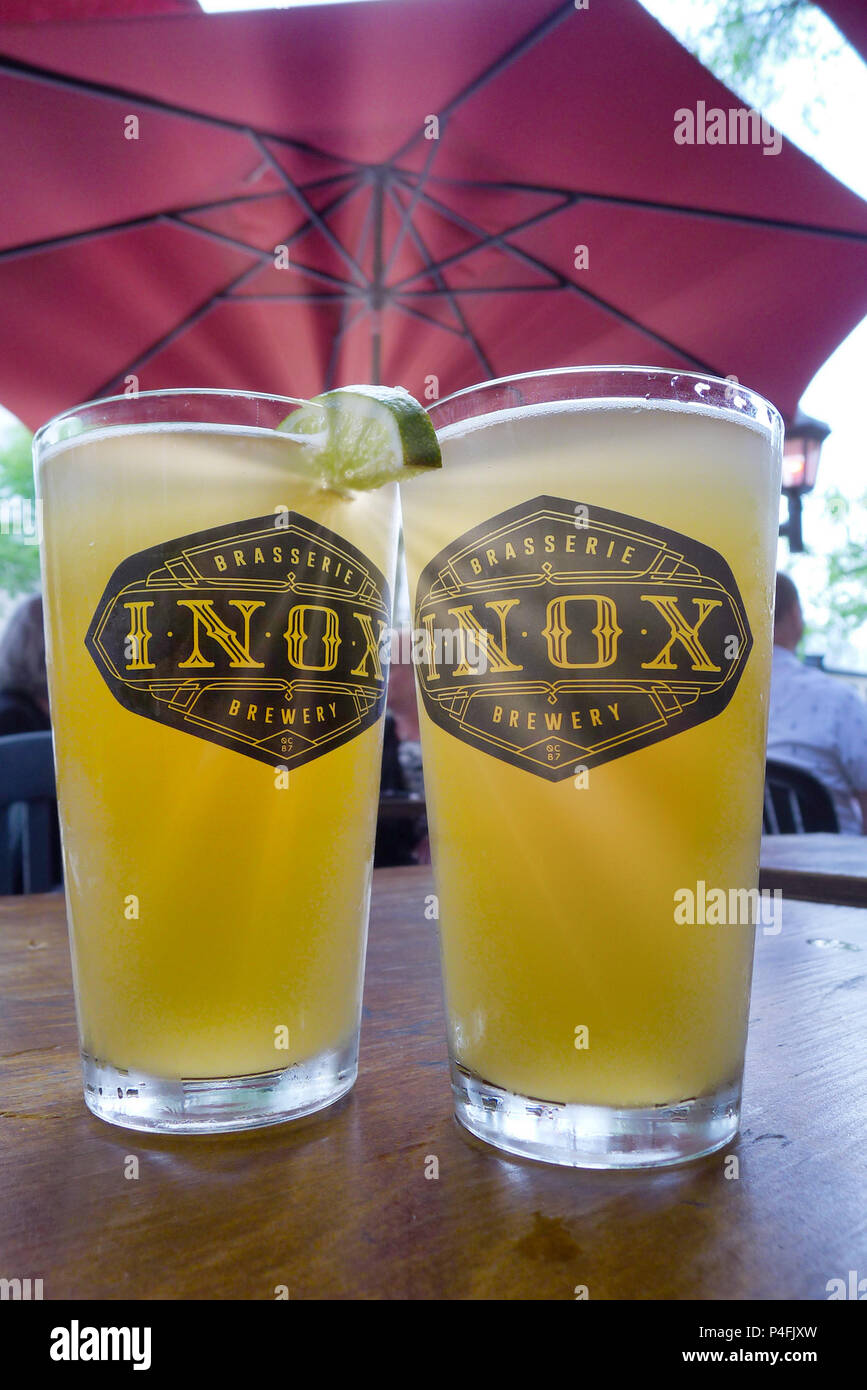 Two pints of wheat beer on a table at the Inox pub on Grande Allée in Quebec City Stock Photo