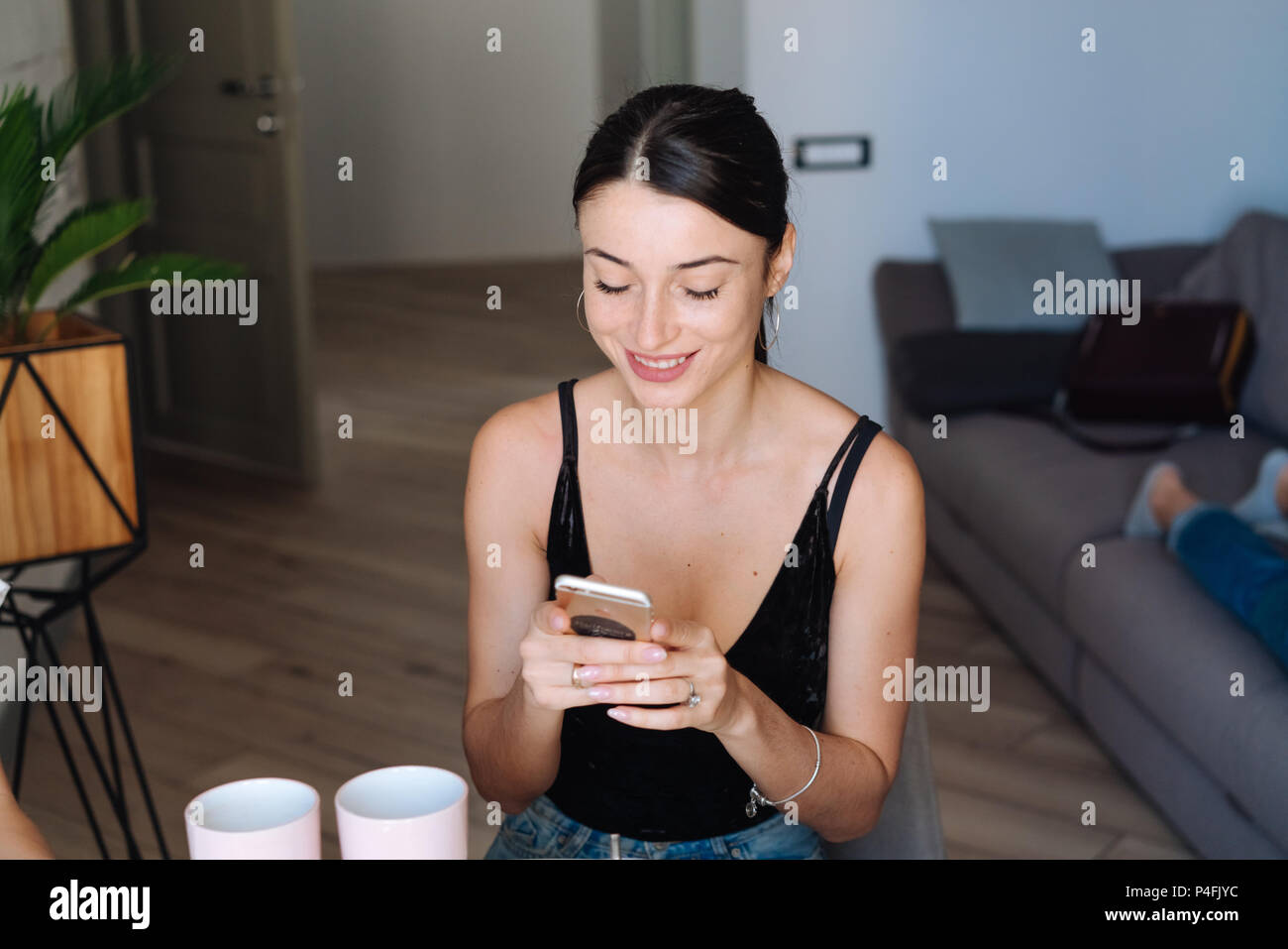 Girl Getting A Message Happy girl reading a message in a smart phone Stock Photo - Alamy
