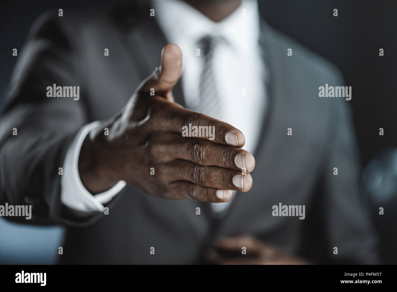 partial view of african american businessman with outstretched hand Stock Photo