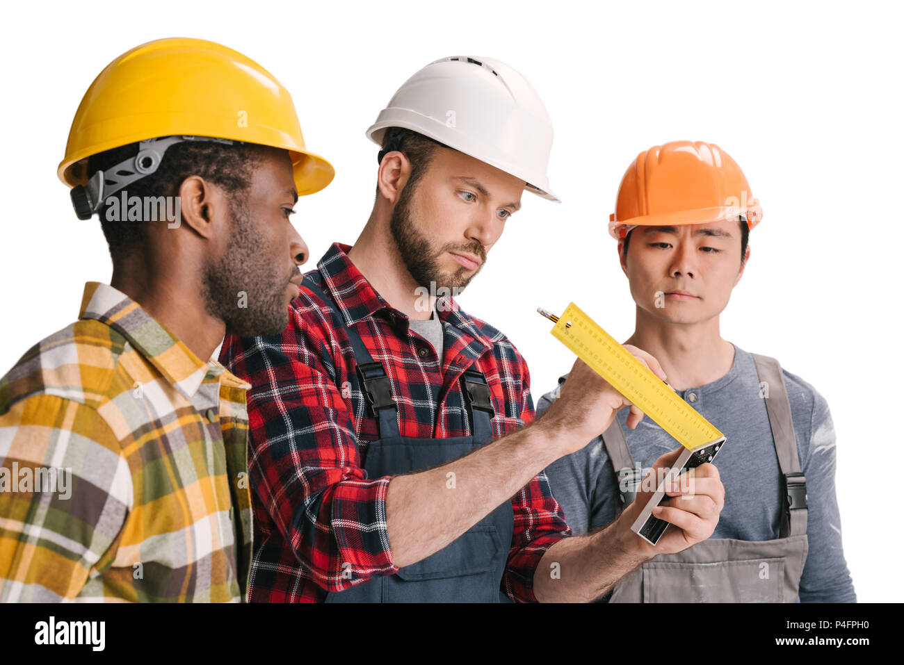 group of multiethnic construction workers looking at ruler Stock Photo ...