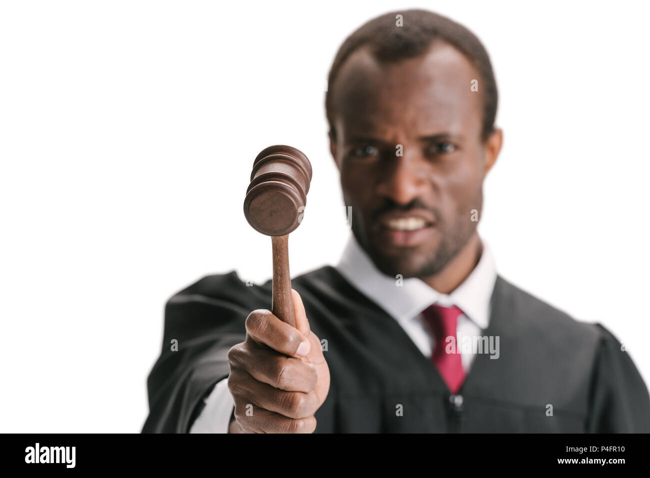 critical judge pointing at camera with gavel isolated on white Stock