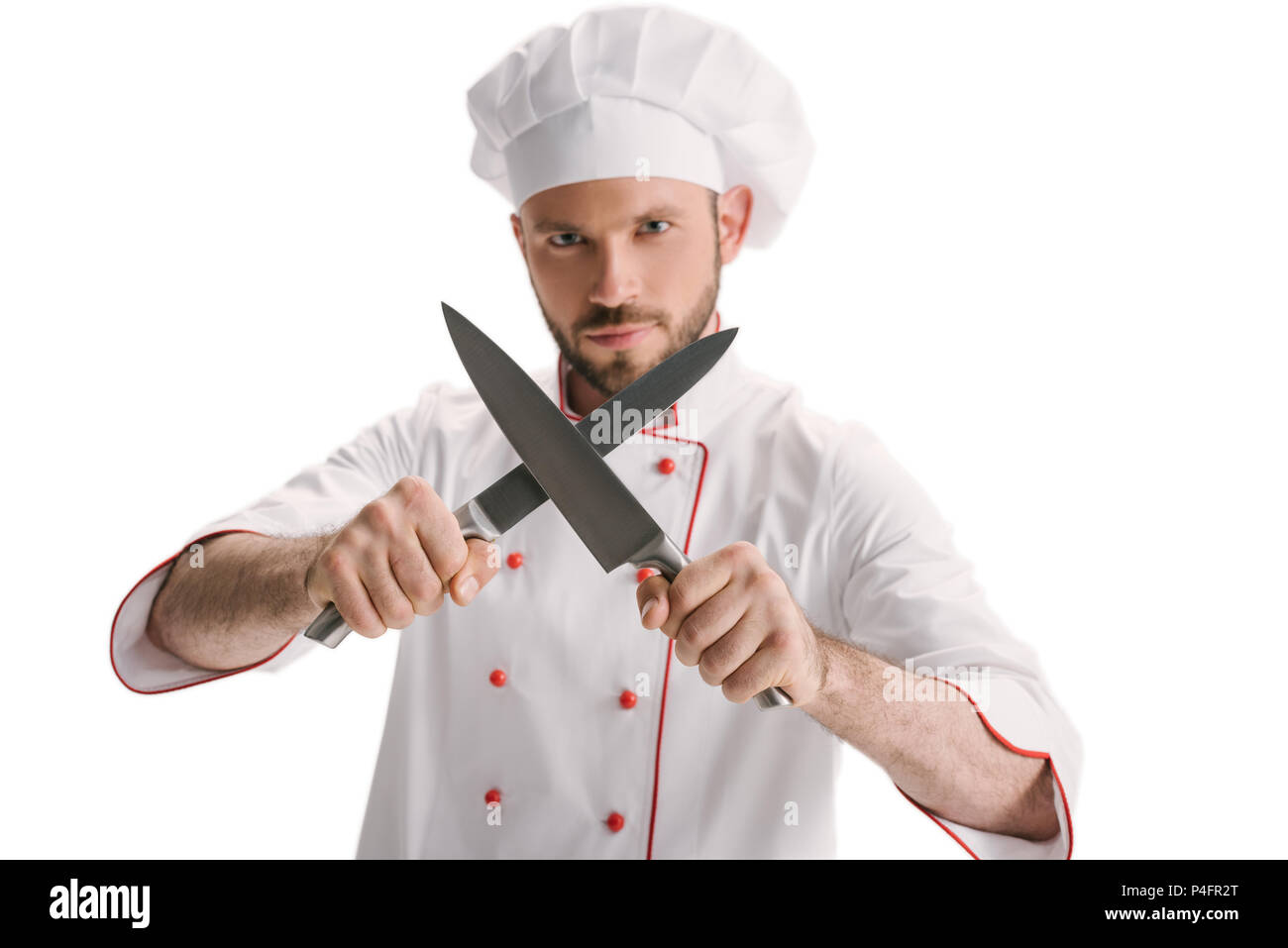 handsome young chef sharpening knives isolated on white Stock Photo