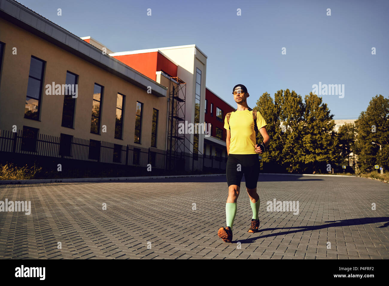 A man in sports clothes walks in the city Stock Photo