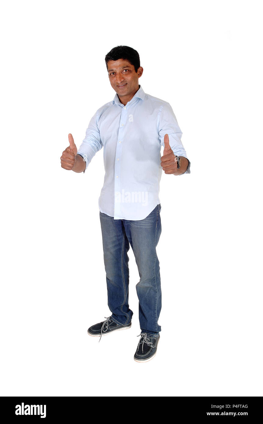 A full body image on an East Indian man in jeans and blue shirt standing with booths of his thumps up, isolated for white background Stock Photo