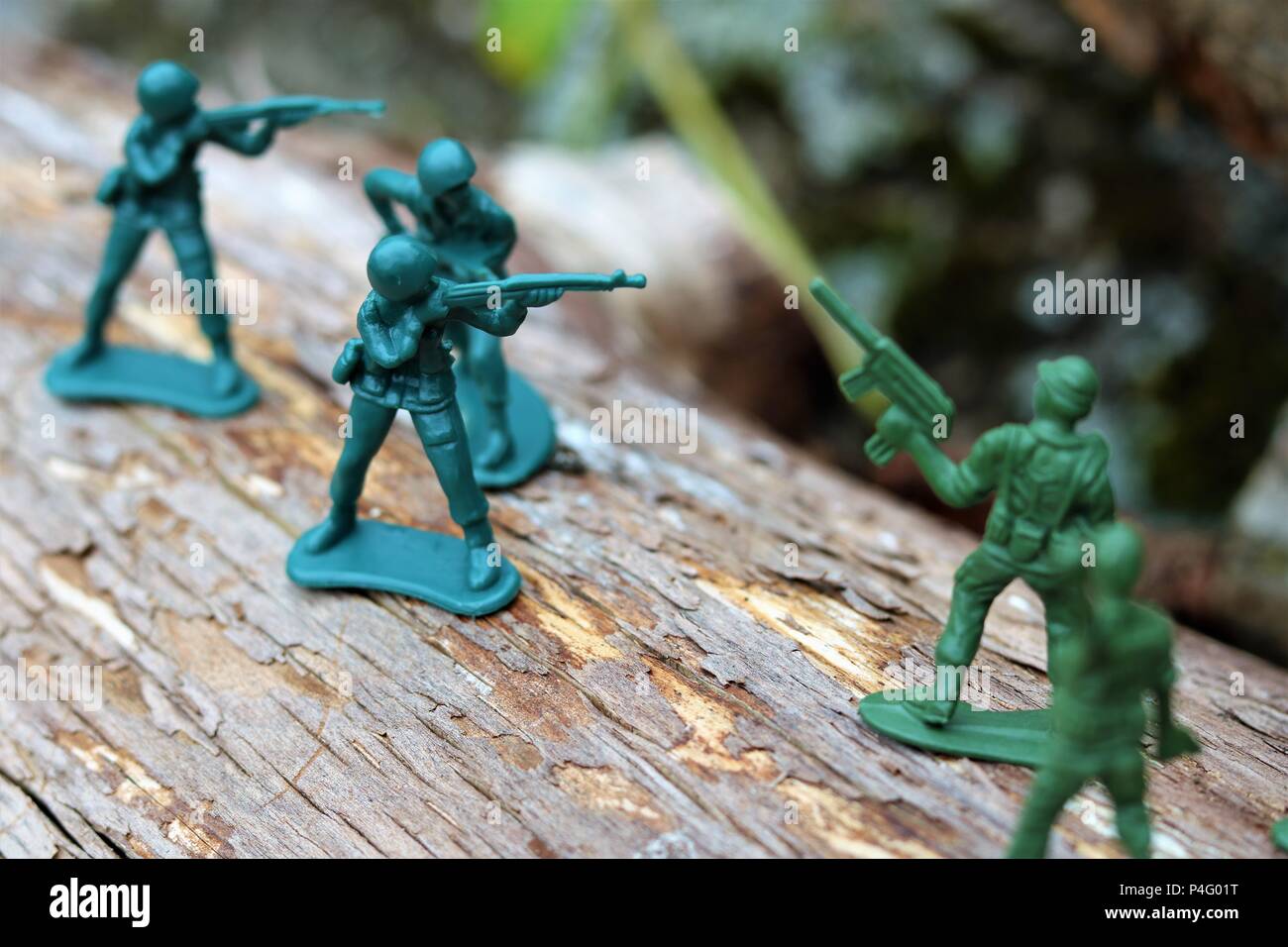 Plastic toy soldiers showing a battle scene - News Concept Stock Photo