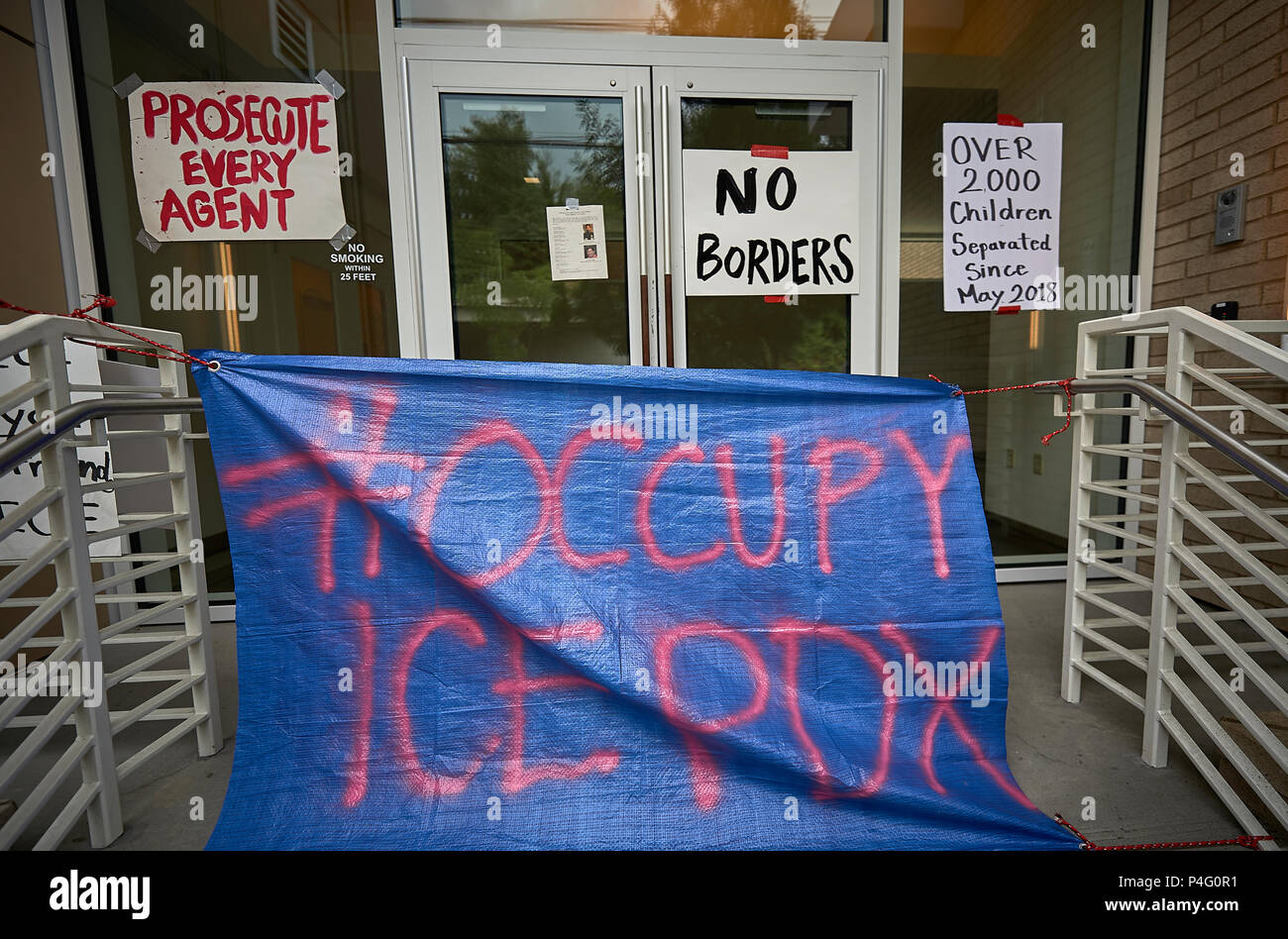 Portland, Oregon, USA. 21 June, 2018. An entrance to the field office of the United States Immigration and Customs Enforcement (ICE) in Portland, Oregon. The office was blockaded by protestors for several days before stopping operations on June 20. Protestors are objecting to the separation of families detained while seeking asylum on the U.S.-Mexico border.  Credit: Paul Jeffrey/Alamy Live News Stock Photo