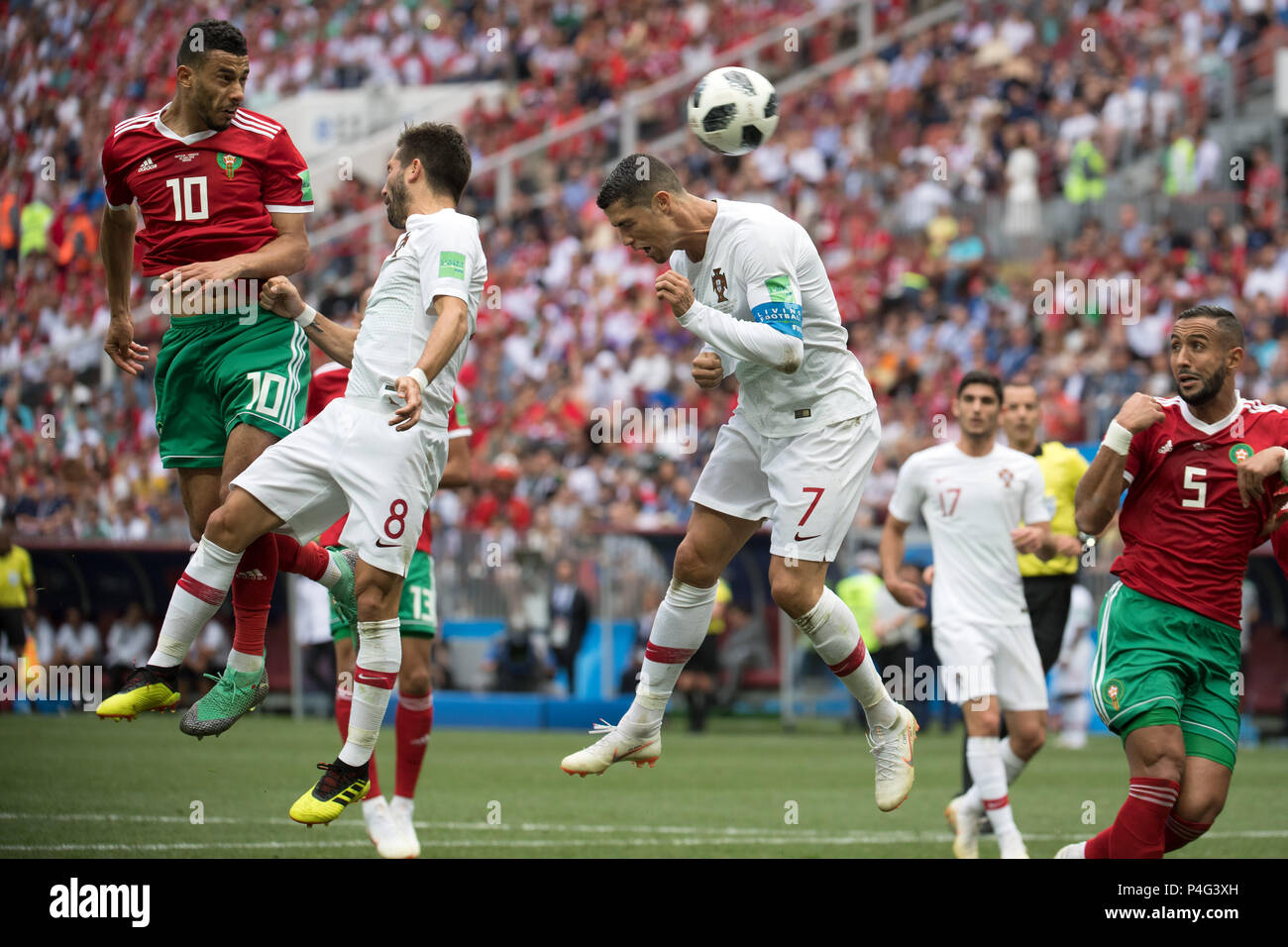 Moscow, Soccer, Russia. 20th June, 2018. World Cup, Portugal vs Morocco, preliminary round, Group B, 2nd match day in the Luzhniki Stadium: Portugal's Joao Moutinho (C) and Cristiano Ronaldo (R) and Morocco's Younes Belhanda (L) vying for the ball. Credit: Federico Gambarini/dpa/Alamy Live News Stock Photo