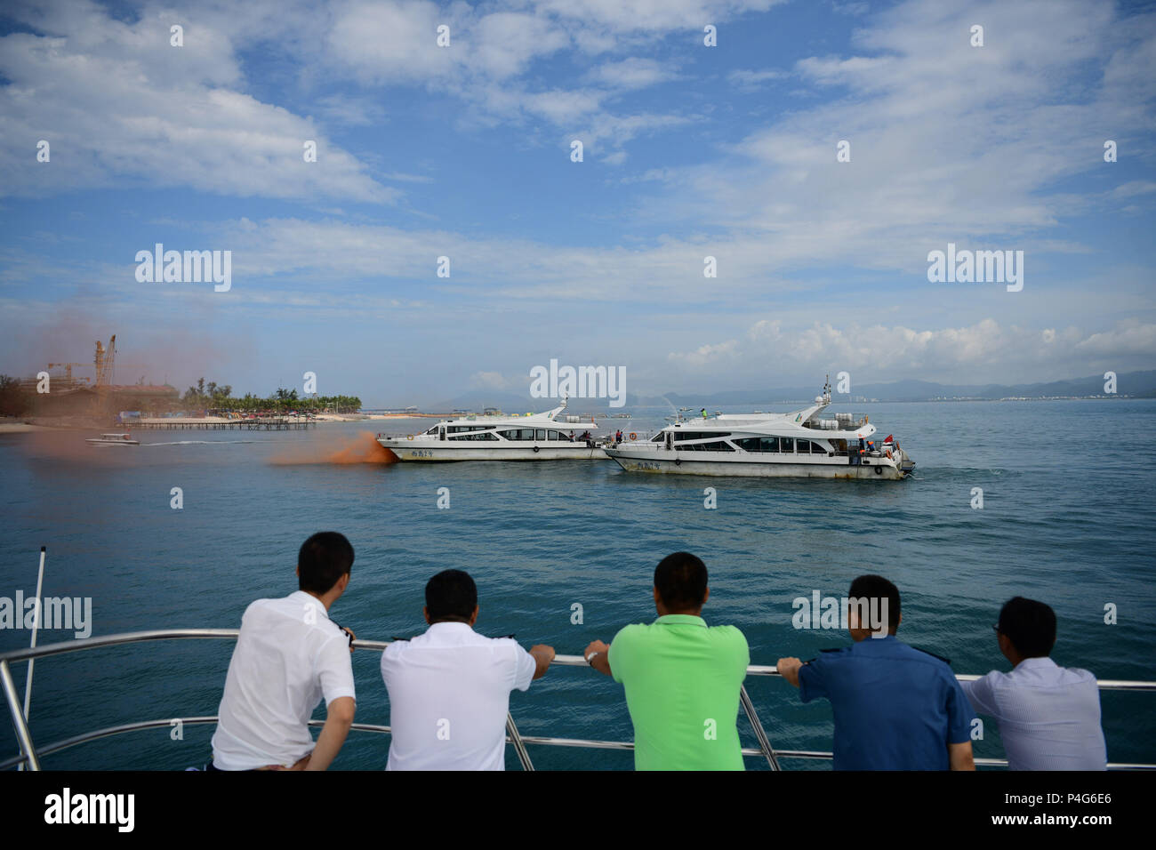 Sanya, China's Hainan Province. 22nd June, 2018. People look on as rescuers participate in an emergency drill on securing marine transportation in Sanya, south China's Hainan Province, June 22, 2018. Credit: Sha Xiaofeng/Xinhua/Alamy Live News Stock Photo
