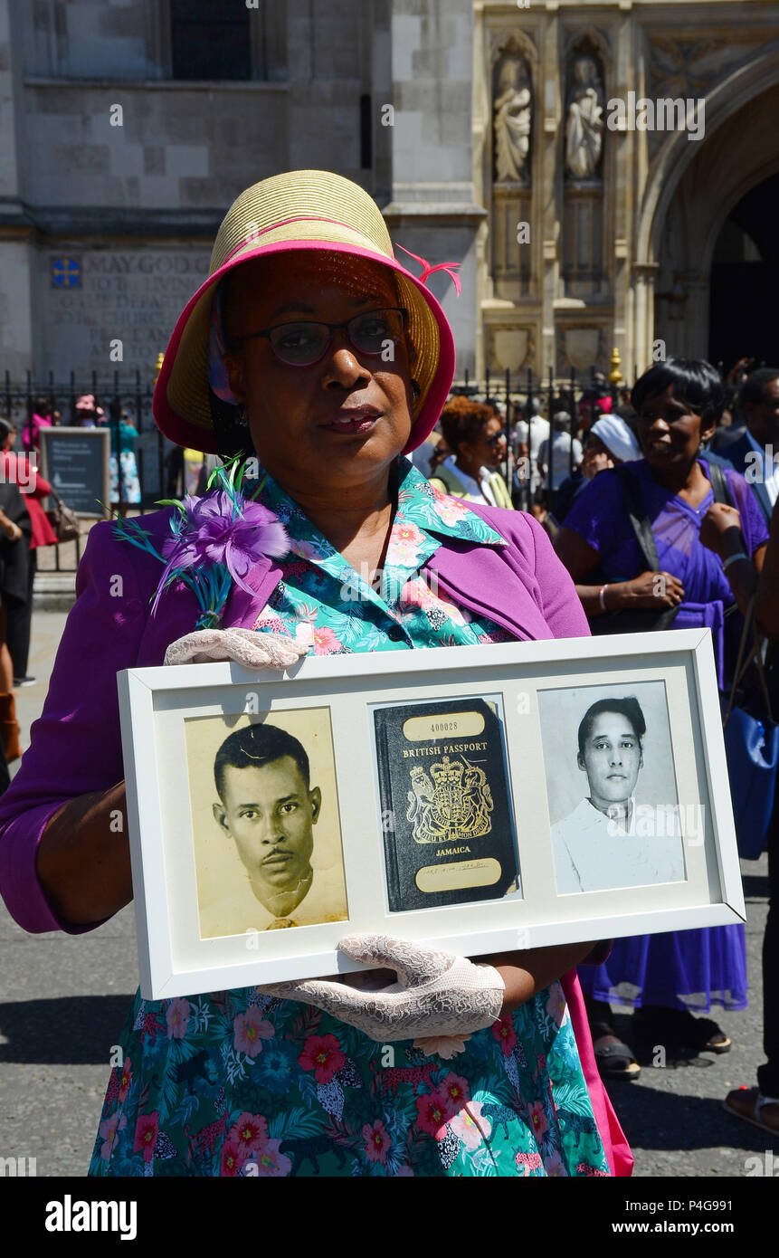 London, UK, 22/06/2018 Andria Marsh, 63, holds photoS of her parents with her original British passport. Windrush 70 year celebration attendees leave after the service at Westminster Abbey. Credit: JOHNNY ARMSTEAD/Alamy Live News Stock Photo