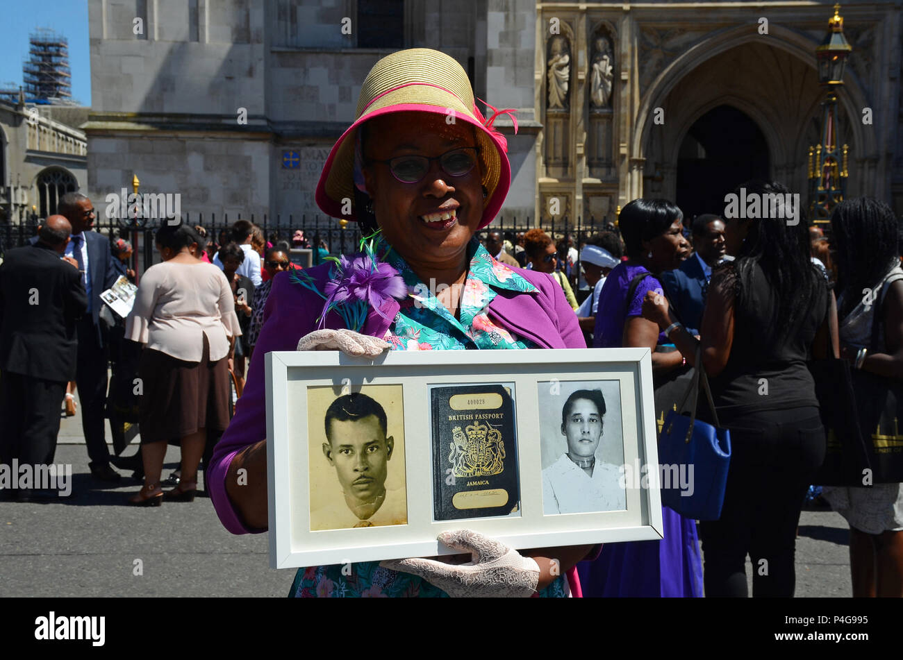 London, UK, 22/06/2018 Andria Marsh, 63, holds photoS of her parents with her original British passport. Windrush 70 year celebration attendees leave after the service at Westminster Abbey. Credit: JOHNNY ARMSTEAD/Alamy Live News Stock Photo