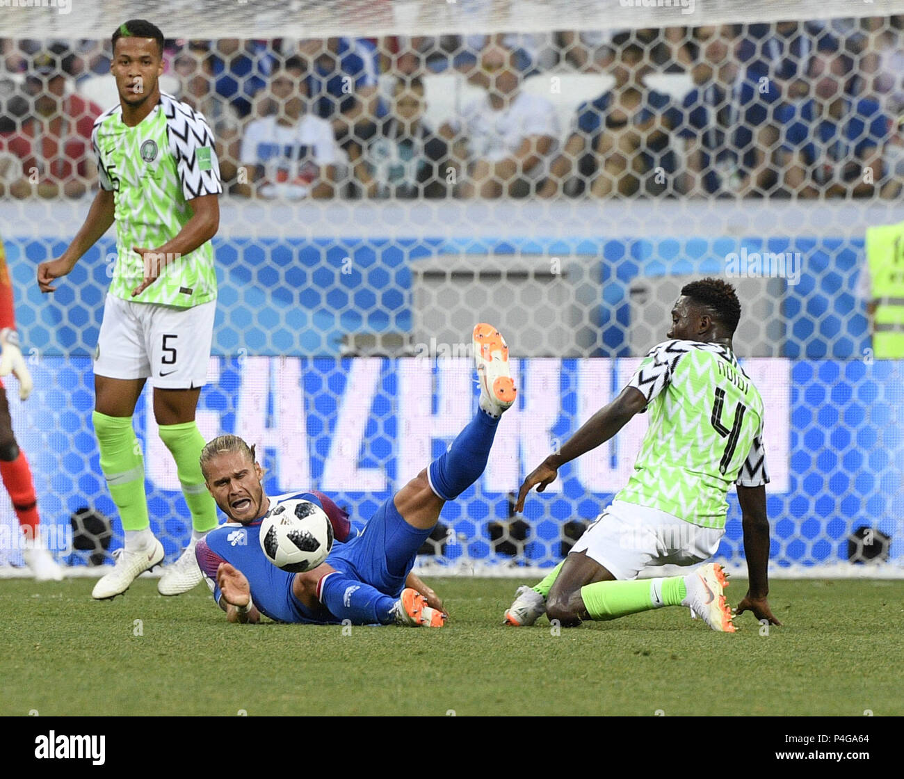 Volgograd, Russia. 22nd June, 2018. Wilfred Ndidi (R) of Nigeria vies with Rurik Gislason (C) of Iceland during the 2018 FIFA World Cup Group D match between Nigeria and Iceland in Volgograd, Russia, June 22, 2018. Nigeria won 2-0. Credit: Lui Siu Wai/Xinhua/Alamy Live News Stock Photo