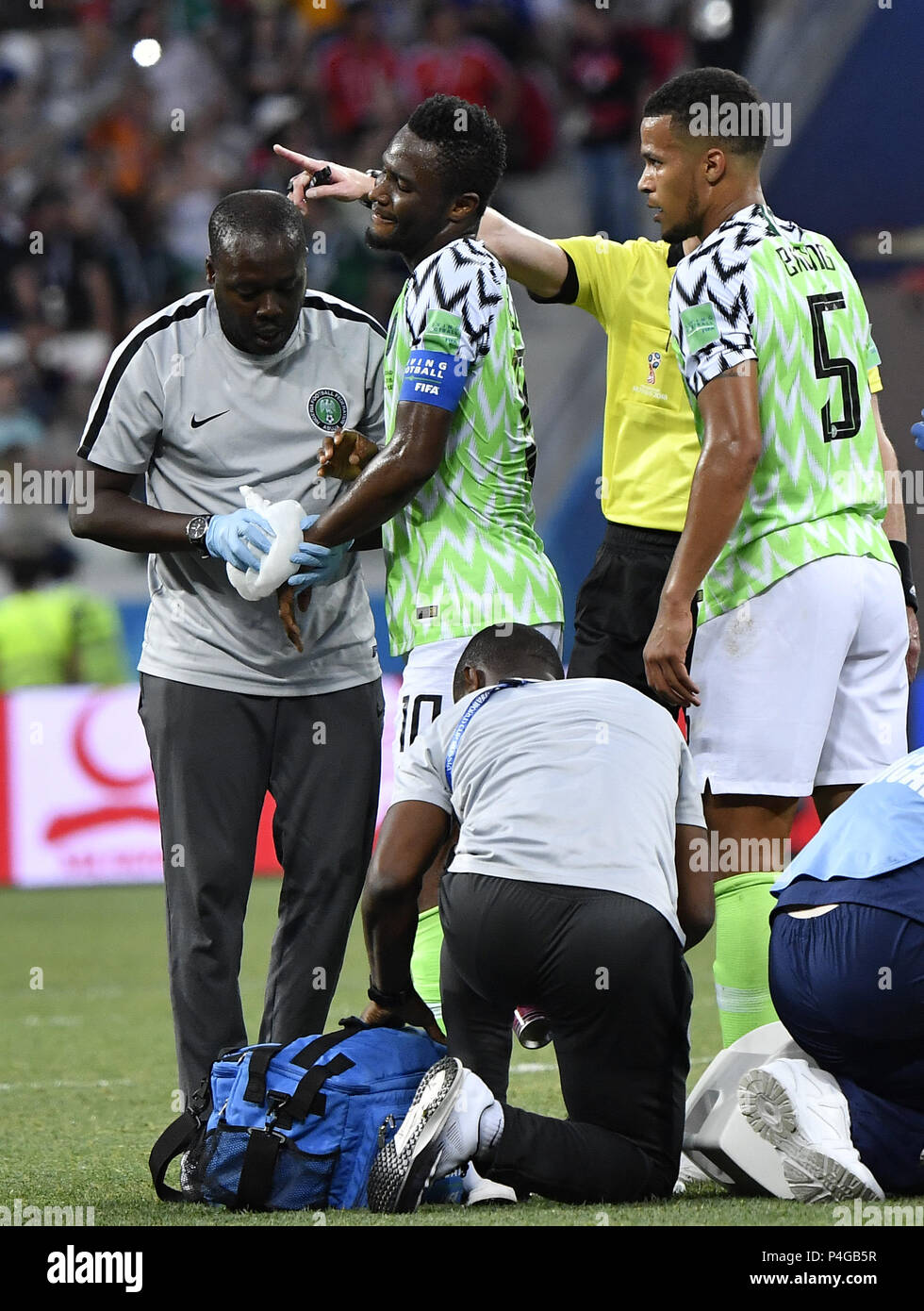 Volgograd, Russia. 22nd June, 2018. John Obi Mikel (C) of Nigeria receives medical treatment during the 2018 FIFA World Cup Group D match between Nigeria and Iceland in Volgograd, Russia, June 22, 2018. Nigeria won 2-0. Credit: He Canling/Xinhua/Alamy Live News Stock Photo