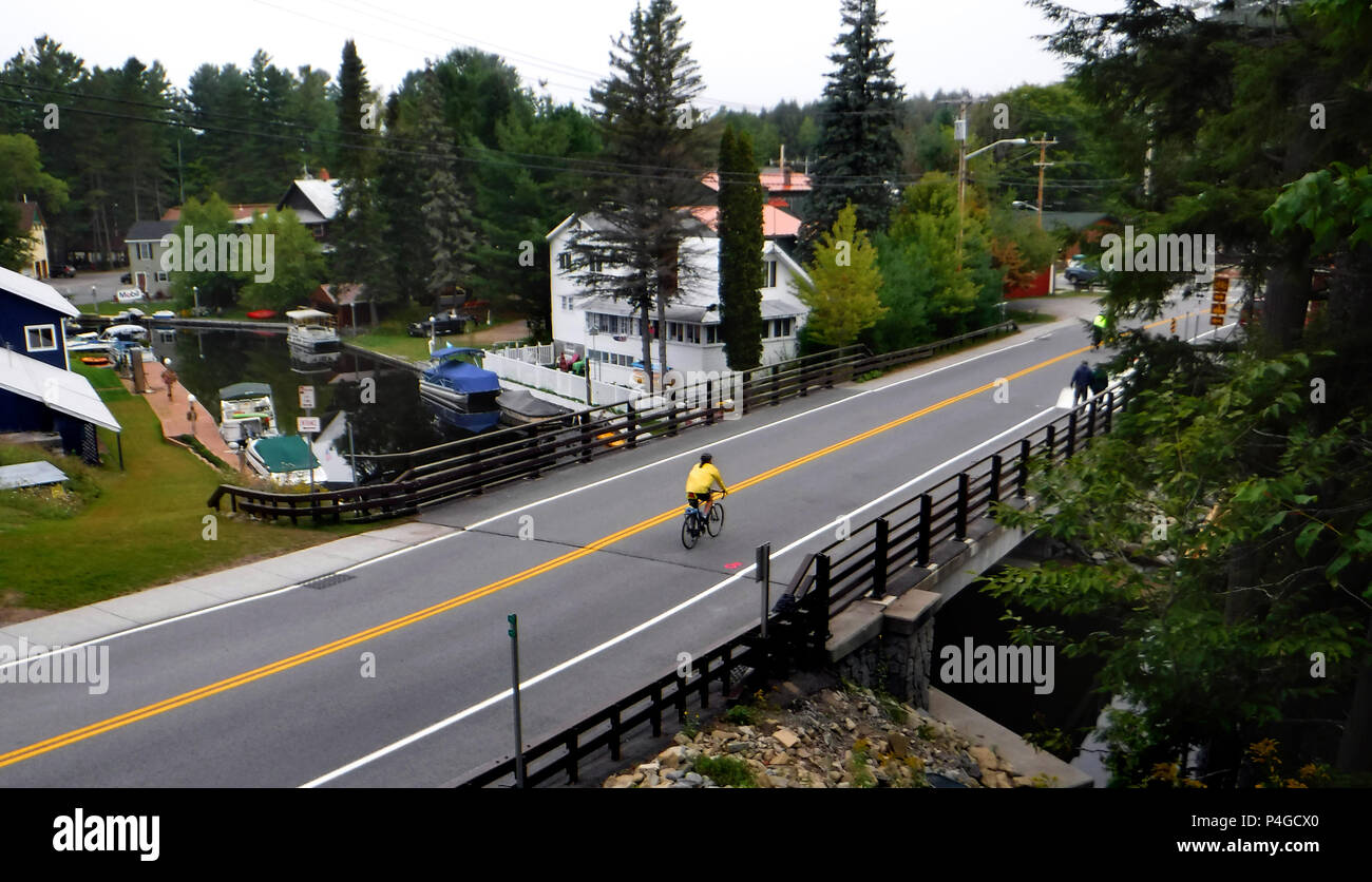Inlet, New York, USA. 28th Aug, 2015. A cyclist arrives in downtown