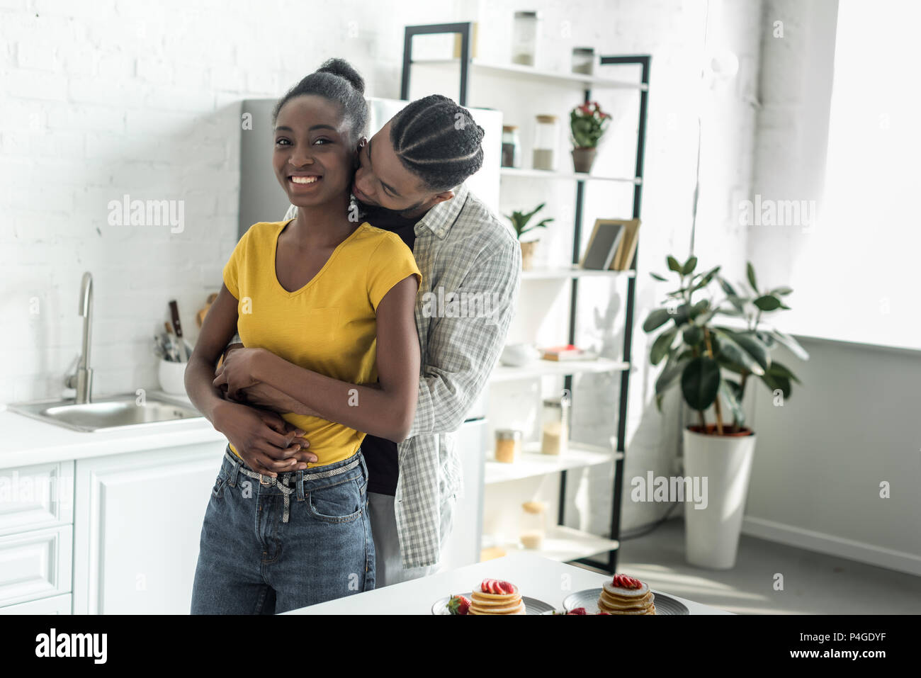 african american couple hugging at kitchen Stock Photo - Alamy