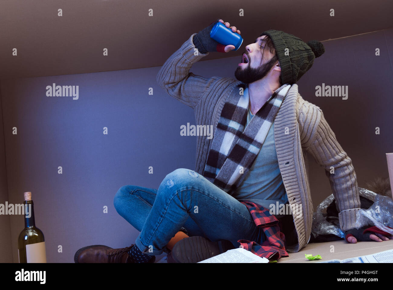 homeless man drinking alcohol while sitting in big cardboard box Stock  Photo - Alamy