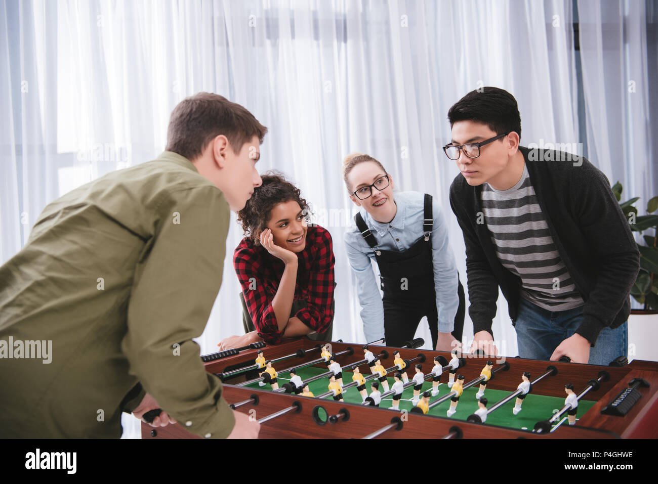 happy young teenagers playing in table soccer Stock Photo