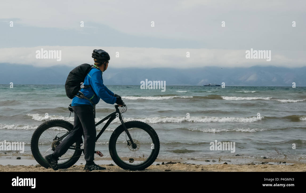 Fat bike also called fatbike or fat tire bike in summer driving on the beach. The